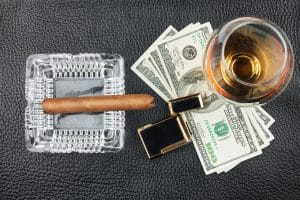 Zigarre und Whiskey mit Feuerzeug und Geld